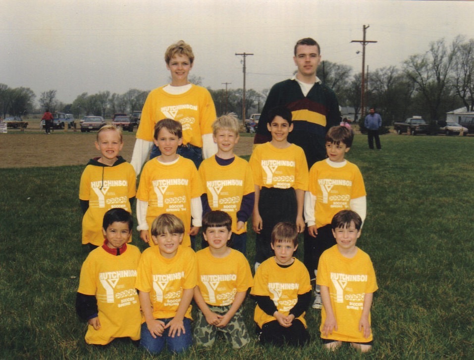 Rebecca and Garrett (back row) with a Hutchinson YMCA youth soccer team; her son Derek is among the players · c. 1994