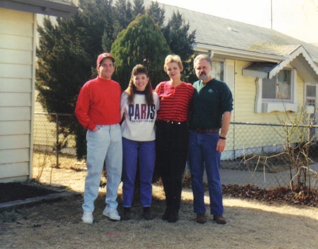 Rebecca with family in front of the house · c. 1993