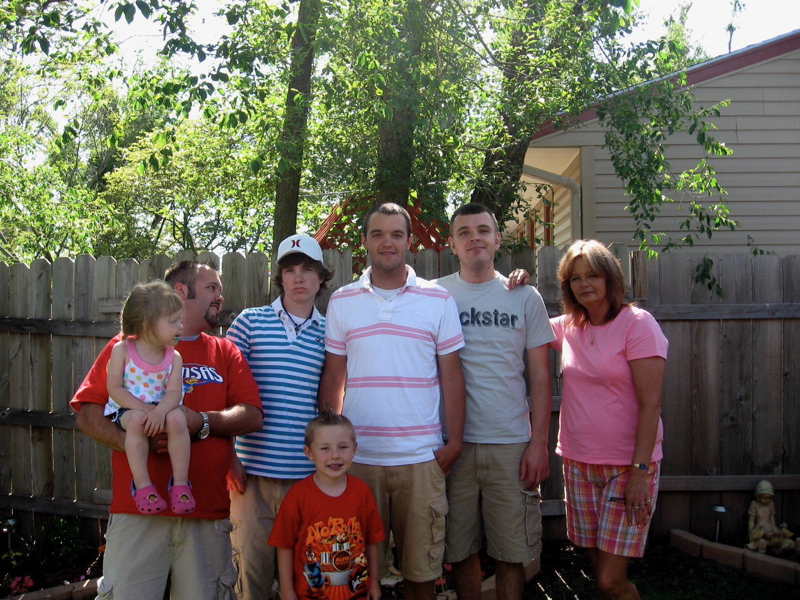 Rebecca with her four sons and grandkids in the backyard