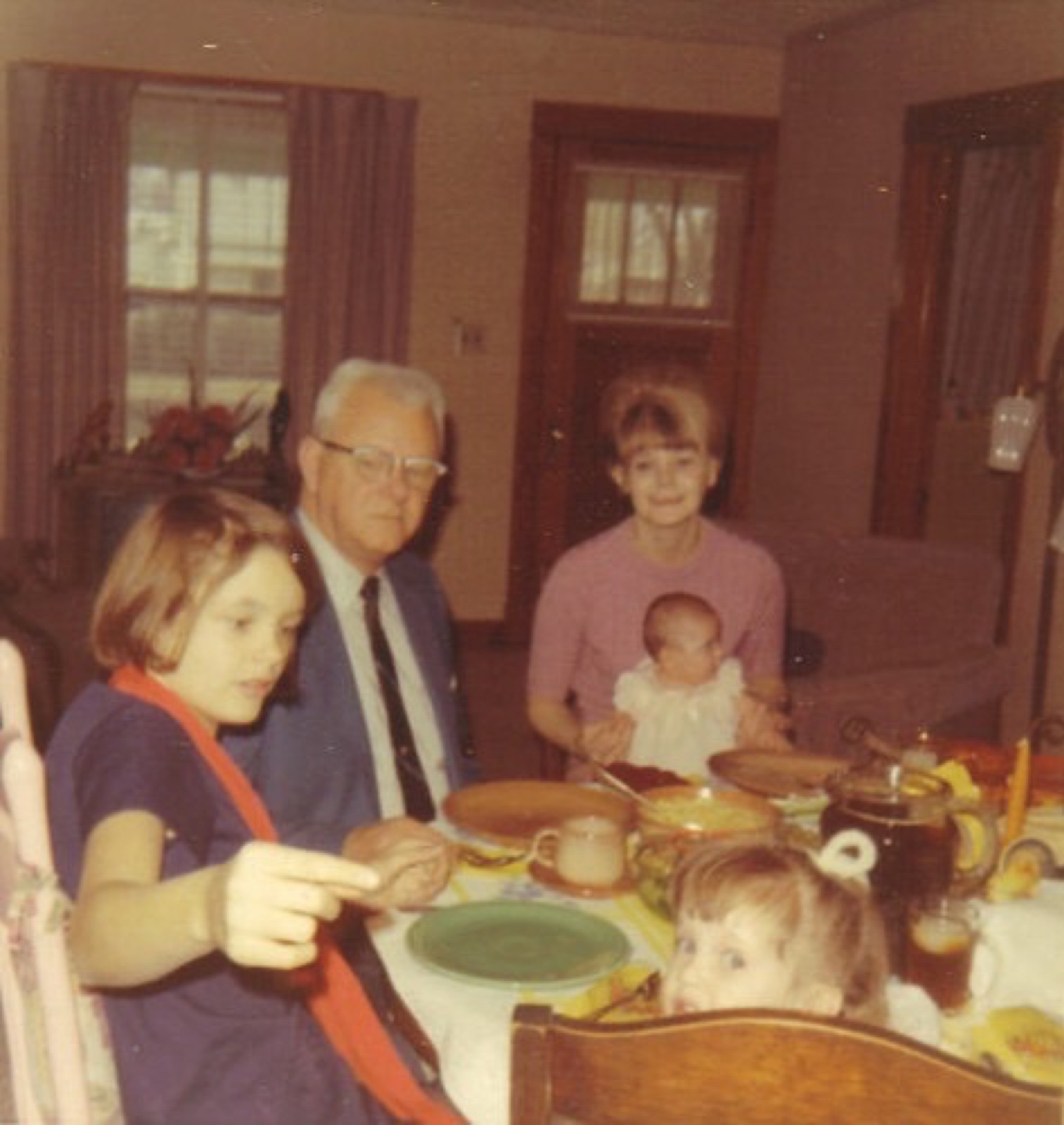 Rebecca as a girl (left) at a family dinner with her father, Oliver, c. 1967